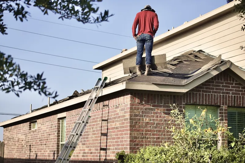 Professional roofer working on a residential roof in Buckingham Court